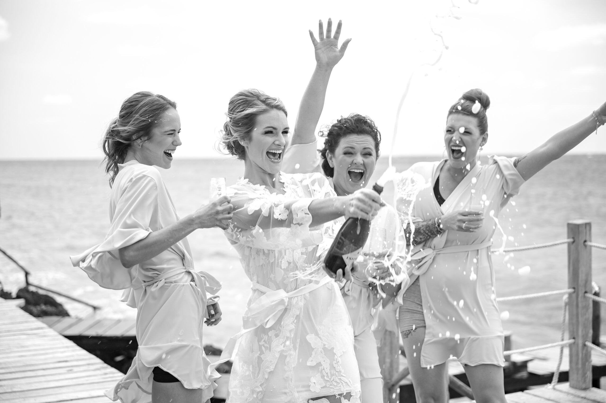 Bridesmaids celebrating during a Riviera Maya destination wedding photography by Poga Studios