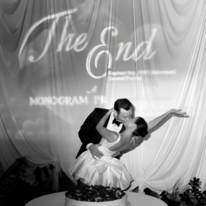 Bride and groom celebrating diring the reception, behind a projecyion mapping