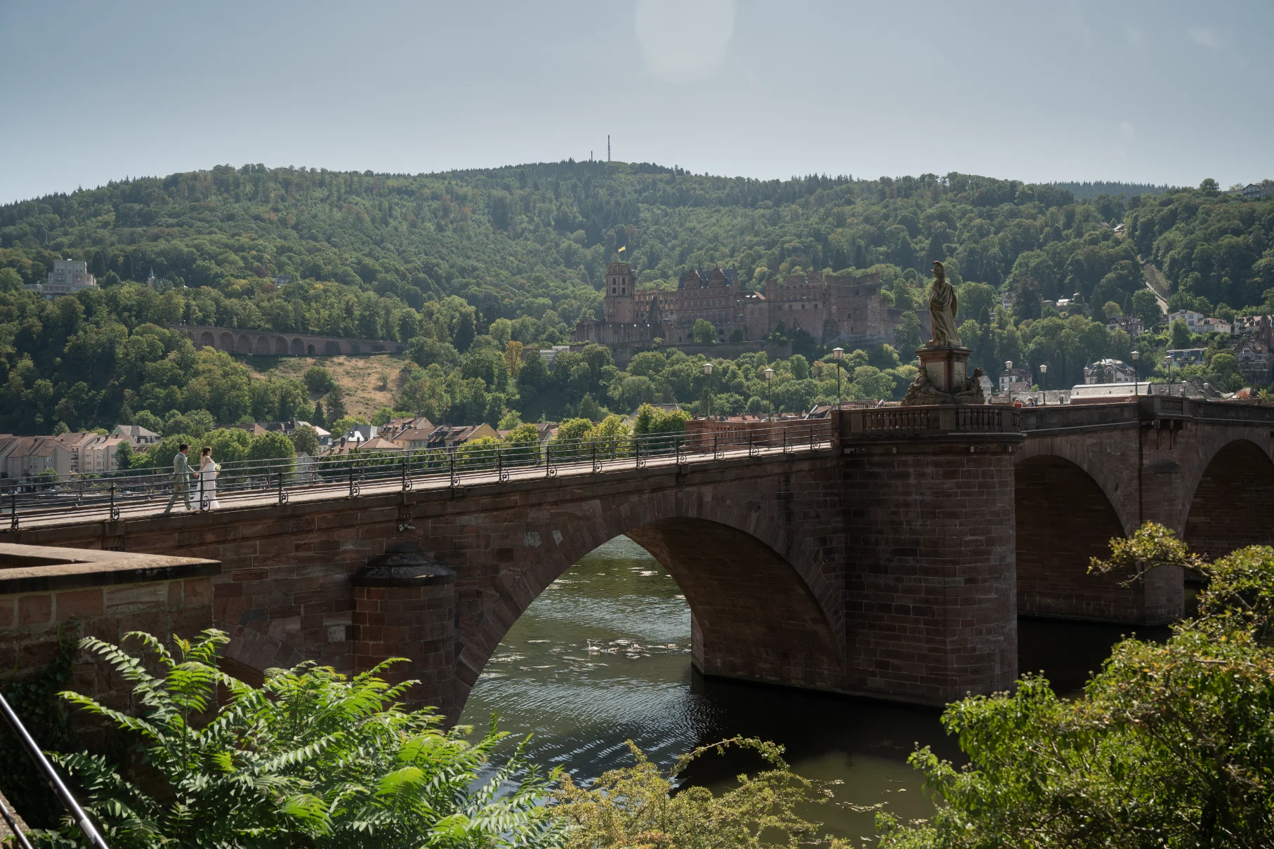 Bride and Groom walking through Heidelberg Bridge, Germany, Photography by Poga Studios
